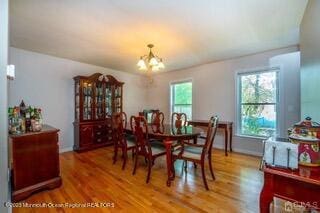 dining space featuring a chandelier and light wood finished floors