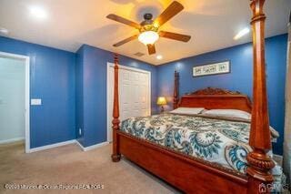 bedroom featuring baseboards, carpet floors, and a ceiling fan