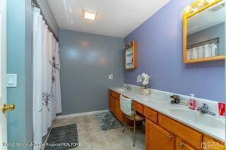 full bath with vanity and curtained shower