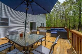 wooden terrace with outdoor dining area and an outdoor hangout area