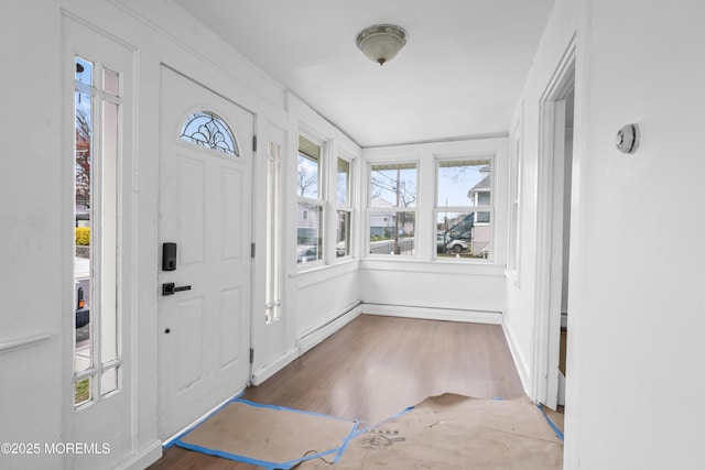 101 Forest Ave, Keansburg, NJ 07734 - foyer entrance featuring wood finished floors, baseboards, and a baseboard heating unit