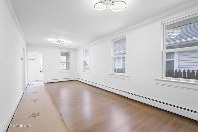 101 Forest Ave, Keansburg, NJ 07734 - spare room with ornamental molding, a baseboard radiator, wood finished floors, baseboards, and a chandelier