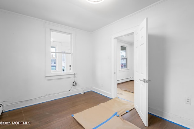 101 Forest Ave, Keansburg, NJ 07734 - unfurnished room featuring a baseboard radiator, wood finished floors, healthy amount of natural light, and ornamental molding