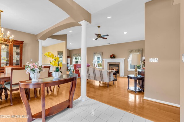 4 Saxony Cir, Manchester, NJ 08759 - dining room featuring decorative columns, a ceiling fan, a high end fireplace, light tile patterned floors, and arched walkways
