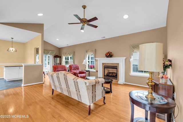 4 Saxony Cir, Manchester, NJ 08759 - living area featuring ceiling fan, plenty of natural light, light wood-type flooring, vaulted ceiling, and a fireplace