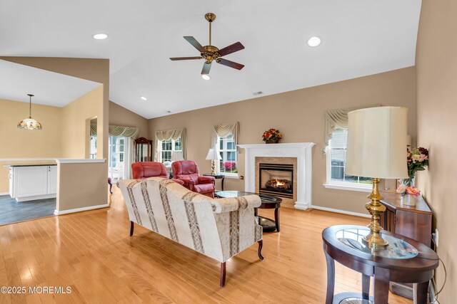 4 Saxony Cir, Manchester, NJ 08759 - living room with a ceiling fan, healthy amount of natural light, light wood-style flooring, a premium fireplace, and lofted ceiling