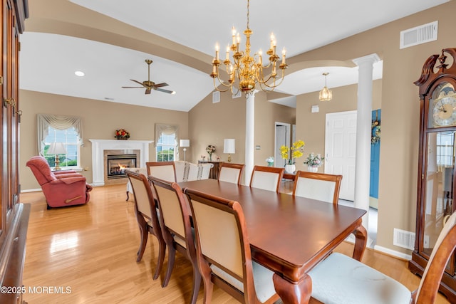 4 Saxony Cir, Manchester, NJ 08759 - dining room featuring ceiling fan, light wood-type flooring, a fireplace, healthy amount of natural light, and lofted ceiling