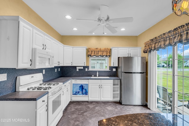 4 Saxony Cir, Manchester, NJ 08759 - kitchen featuring white appliances, a sink, dark countertops, healthy amount of natural light, and recessed lighting
