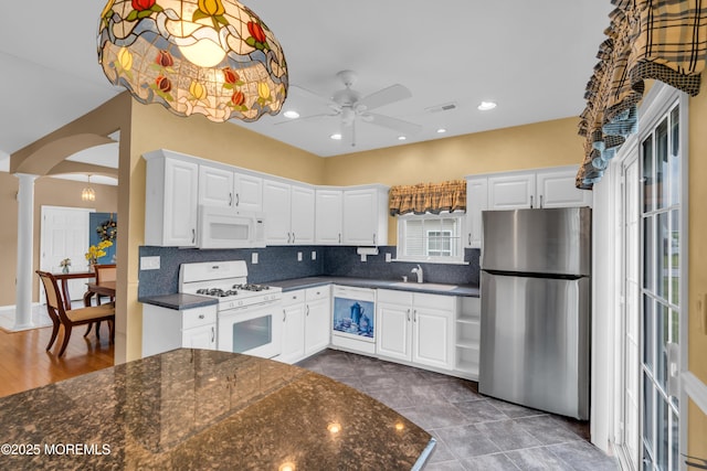 4 Saxony Cir, Manchester, NJ 08759 - kitchen featuring white appliances, a sink, ceiling fan, arched walkways, and backsplash
