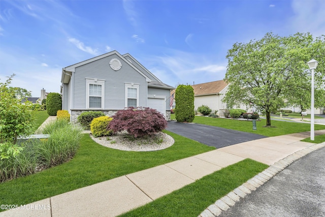 4 Saxony Cir, Manchester, NJ 08759 - view of front of property featuring stone siding, asphalt driveway, a front lawn, and an attached garage