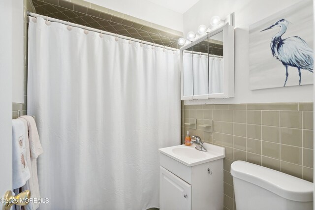1316 Ocean Ave, Point Pleasant Beach, NJ 08742 - bathroom with toilet, vanity, tile walls, and a shower with curtain