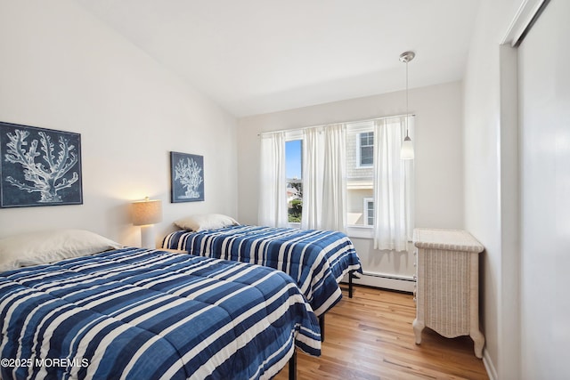 1316 Ocean Ave, Point Pleasant Beach, NJ 08742 - bedroom featuring baseboard heating, wood finished floors, and lofted ceiling