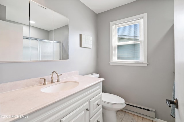 39 Patmore Rd, Brick, NJ 08724 - full bathroom featuring a baseboard radiator, a shower stall, toilet, vanity, and baseboards