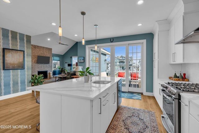 1709 Certainty Dr, Point Pleasant, NJ 08742 - kitchen featuring a sink, stainless steel appliances, light wood-style floors, ceiling fan, and white cabinetry