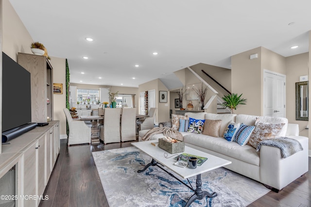 living room featuring stairs, dark wood-style floors, and recessed lighting