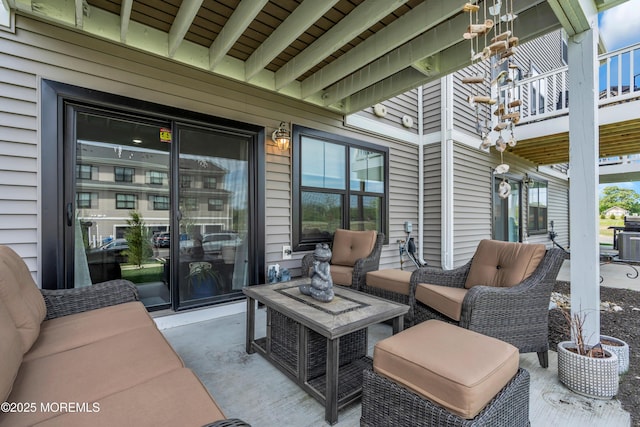 view of patio featuring a balcony, outdoor lounge area, and grilling area