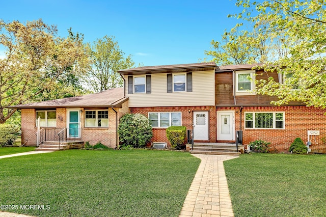 view of front facade with a front lawn and brick siding
