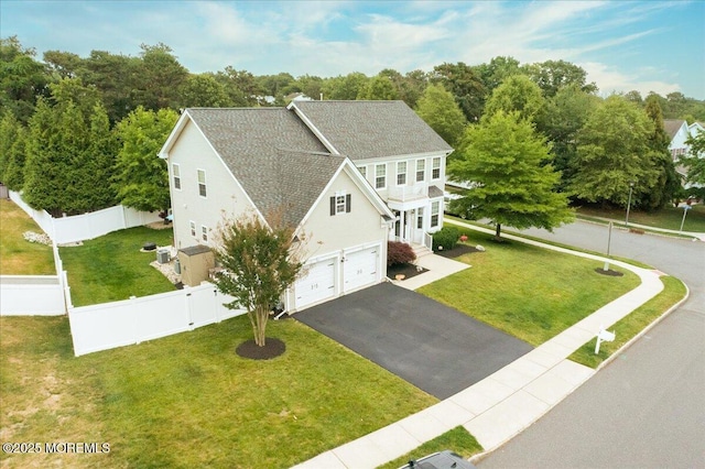 view of front facade with an attached garage, asphalt driveway, and a shingled roof
