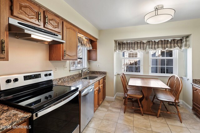 36C Canterbury Dr, Monroe, NJ 08831 - kitchen with stainless steel appliances, under cabinet range hood, a sink, stone countertops, and brown cabinetry