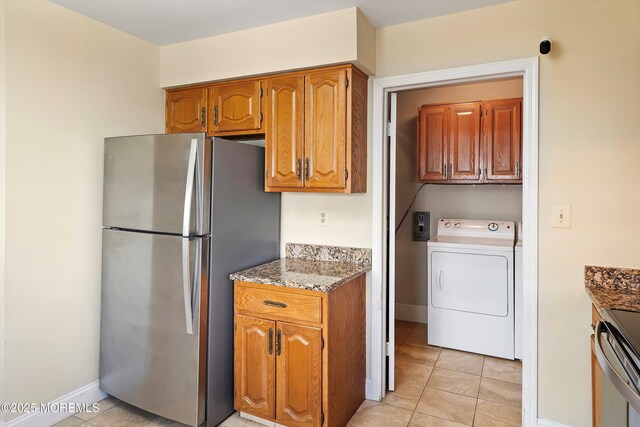 36C Canterbury Dr, Monroe, NJ 08831 - kitchen with washer / dryer, appliances with stainless steel finishes, brown cabinets, baseboards, and light tile patterned flooring