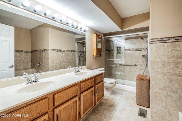 36C Canterbury Dr, Monroe, NJ 08831 - bathroom with a stall shower, toilet, double vanity, tile patterned floors, and tile walls