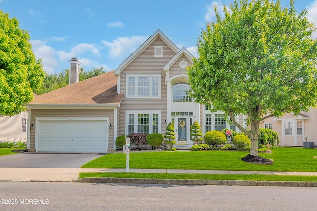 6 Ripple Ter, Barnegat, NJ 08005 - traditional home with an attached garage, concrete driveway, a front yard, a chimney, and central air condition unit