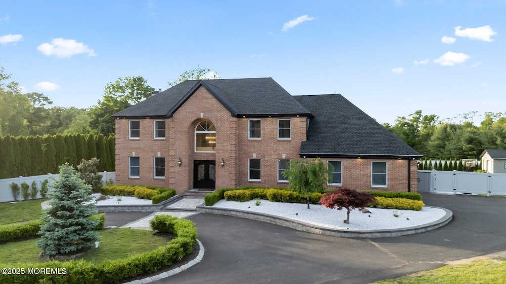 489 E Freehold Rd, Freehold, NJ 07728 - view of front facade with a gate, french doors, brick siding, and roof with shingles