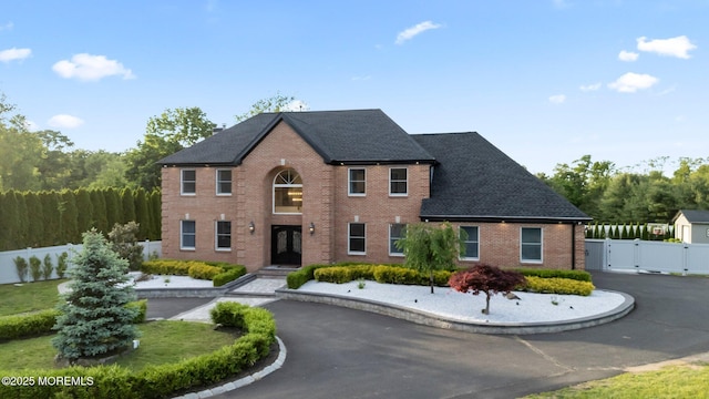 489 E Freehold Rd, Freehold, NJ 07728 - view of front facade with a gate, french doors, brick siding, and roof with shingles