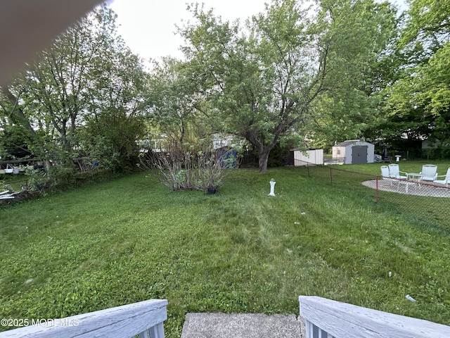 view of yard featuring a storage shed and an outbuilding
