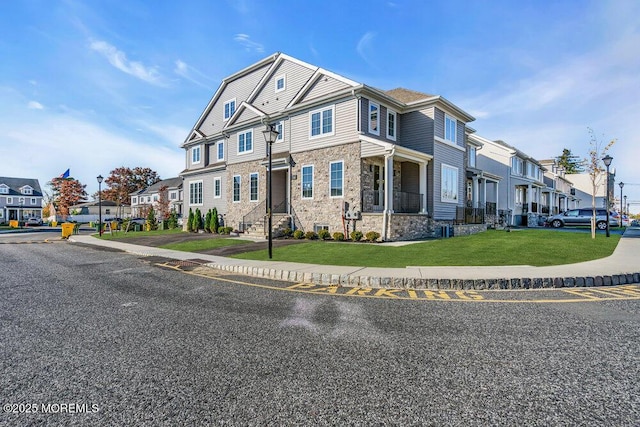 14 Blue River Way, Lakewood, NJ 08701 - townhome / multi-family property with a residential view, stone siding, and a front lawn