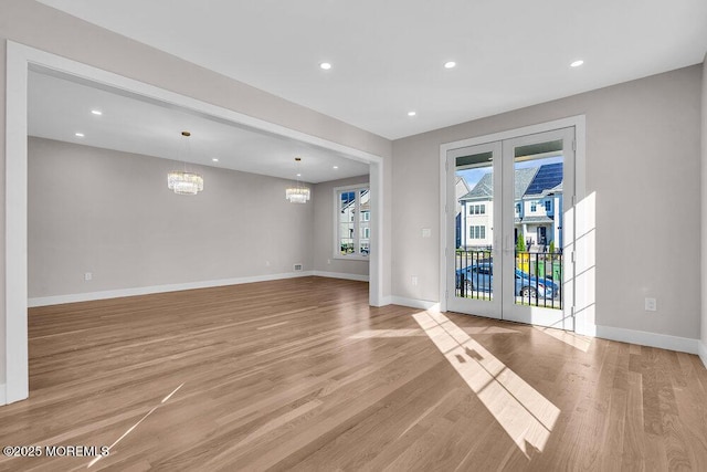 14 Blue River Way, Lakewood, NJ 08701 - unfurnished living room with french doors, a chandelier, light wood-type flooring, baseboards, and recessed lighting