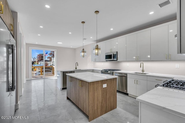 14 Blue River Way, Lakewood, NJ 08701 - kitchen with appliances with stainless steel finishes, a sink, light marble finish flooring, modern cabinets, and recessed lighting