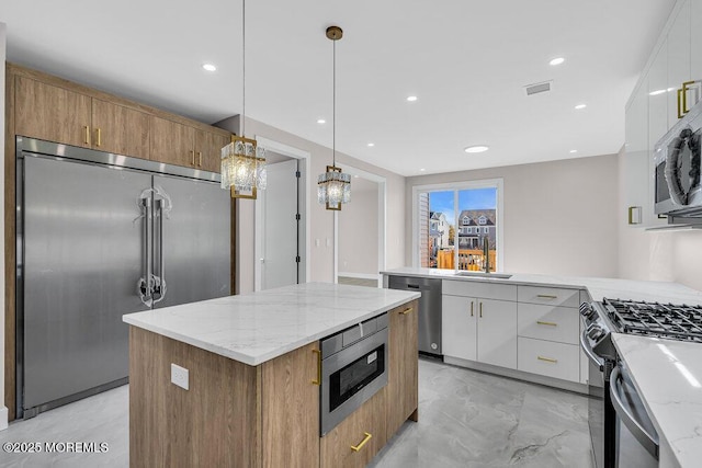14 Blue River Way, Lakewood, NJ 08701 - kitchen with built in appliances, a sink, a chandelier, light marble finish flooring, and light stone countertops