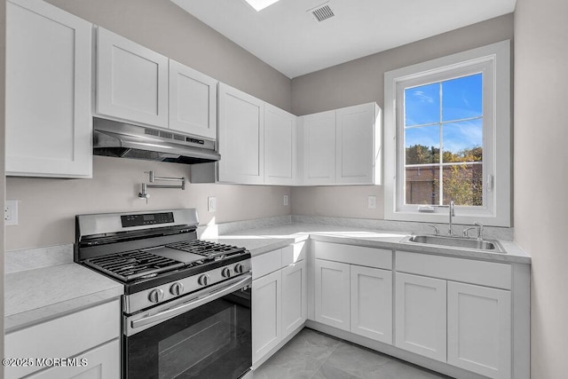 14 Blue River Way, Lakewood, NJ 08701 - kitchen with stainless steel gas range oven, under cabinet range hood, a sink, and white cabinets