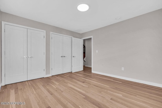 14 Blue River Way, Lakewood, NJ 08701 - unfurnished bedroom featuring two closets, baseboards, and light wood-style flooring