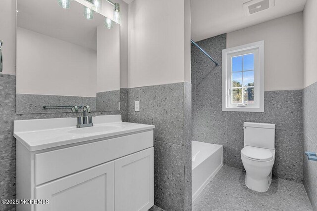 14 Blue River Way, Lakewood, NJ 08701 - bathroom with tile walls, wainscoting, tile patterned floors, toilet, and vanity