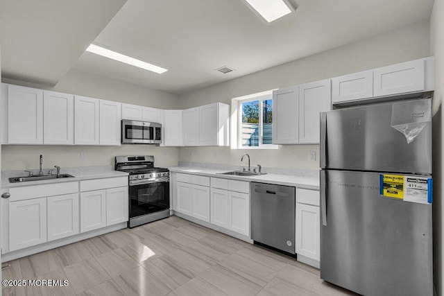 14 Blue River Way, Lakewood, NJ 08701 - kitchen with appliances with stainless steel finishes, a sink, and white cabinetry