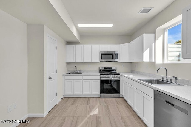 14 Blue River Way, Lakewood, NJ 08701 - kitchen featuring appliances with stainless steel finishes, a sink, and white cabinetry