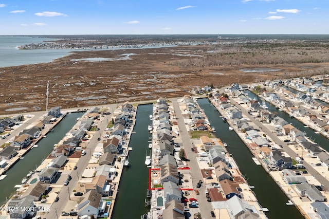 aerial overview of property's location with nearby suburban area and a nearby body of water