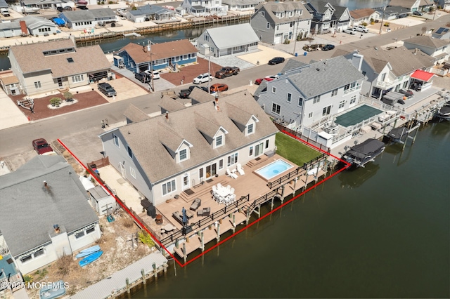 aerial view of residential area with property parcel outlined and a large body of water
