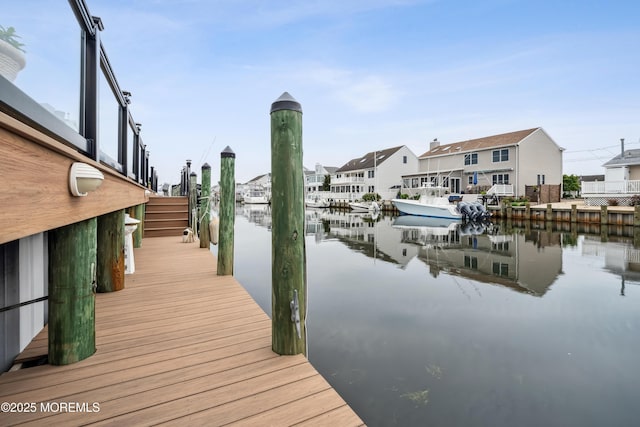 dock area with a water view and a residential view
