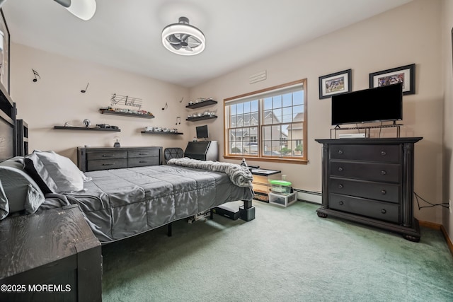 carpeted bedroom featuring a baseboard heating unit and baseboards