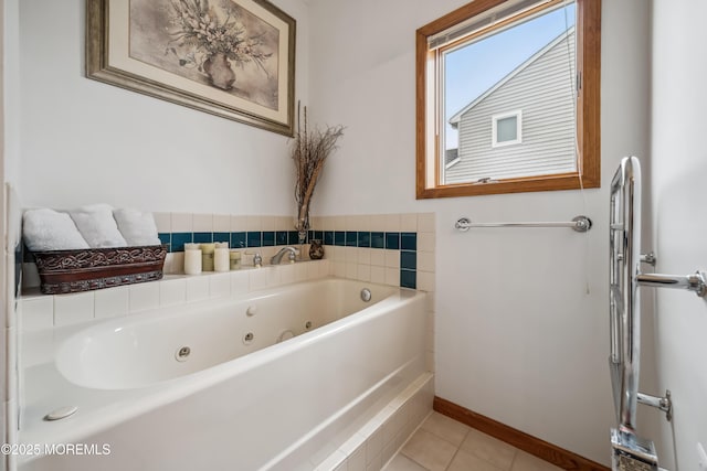 bathroom with a whirlpool tub, tile patterned floors, and baseboards