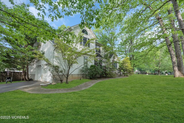view of side of property with driveway and a garage