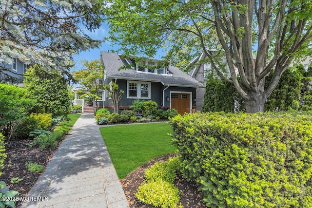 7 Sunset Dr, Asbury Park, NJ 07712 - view of front of house with a front yard and roof with shingles