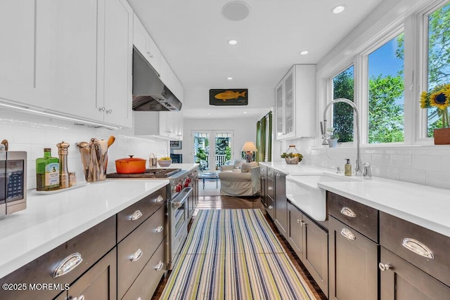 7 Sunset Dr, Asbury Park, NJ 07712 - kitchen featuring under cabinet range hood, stainless steel appliances, a sink, tasteful backsplash, and recessed lighting