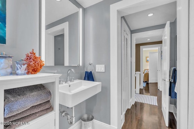 7 Sunset Dr, Asbury Park, NJ 07712 - bathroom with wood finished floors, baseboards, a sink, and recessed lighting