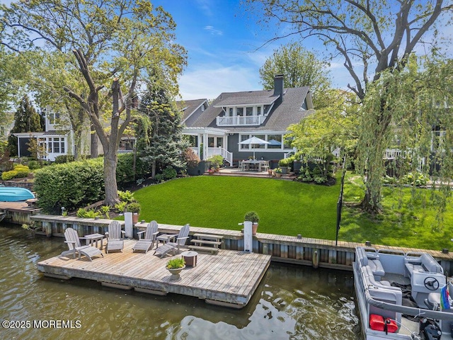 7 Sunset Dr, Asbury Park, NJ 07712 - dock featuring a water view, a lawn, and a patio