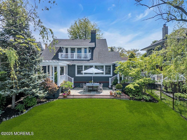 7 Sunset Dr, Asbury Park, NJ 07712 - back of property featuring a patio, a balcony, a chimney, and roof with shingles