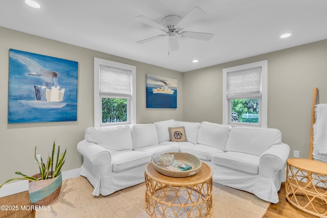 living area featuring healthy amount of natural light, a ceiling fan, recessed lighting, and baseboards